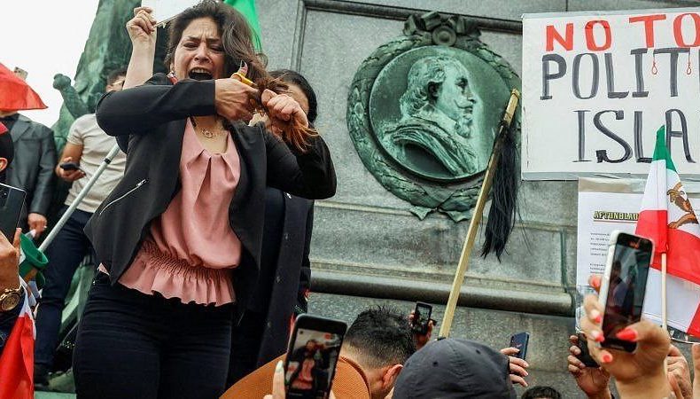 Жінка зрізає своє волосся під час акції протесту в Ірані